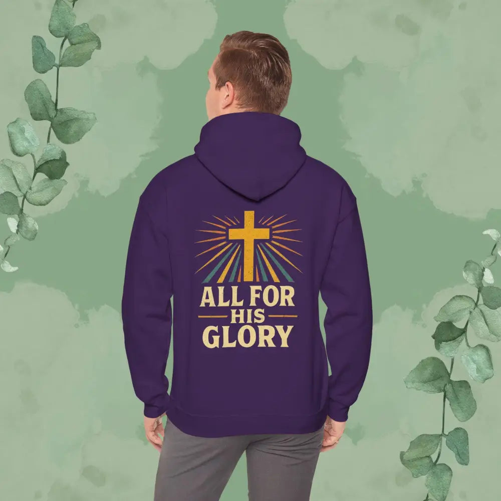 Person wearing a purple hoodie with 'All for His Glory' text and cross design on the back, against a green leafy background.