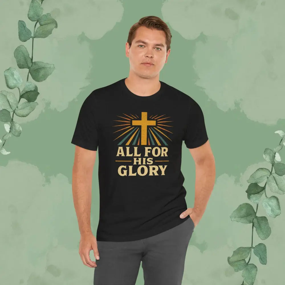 Man wearing a black t-shirt with a cross and text design on a green leafy background