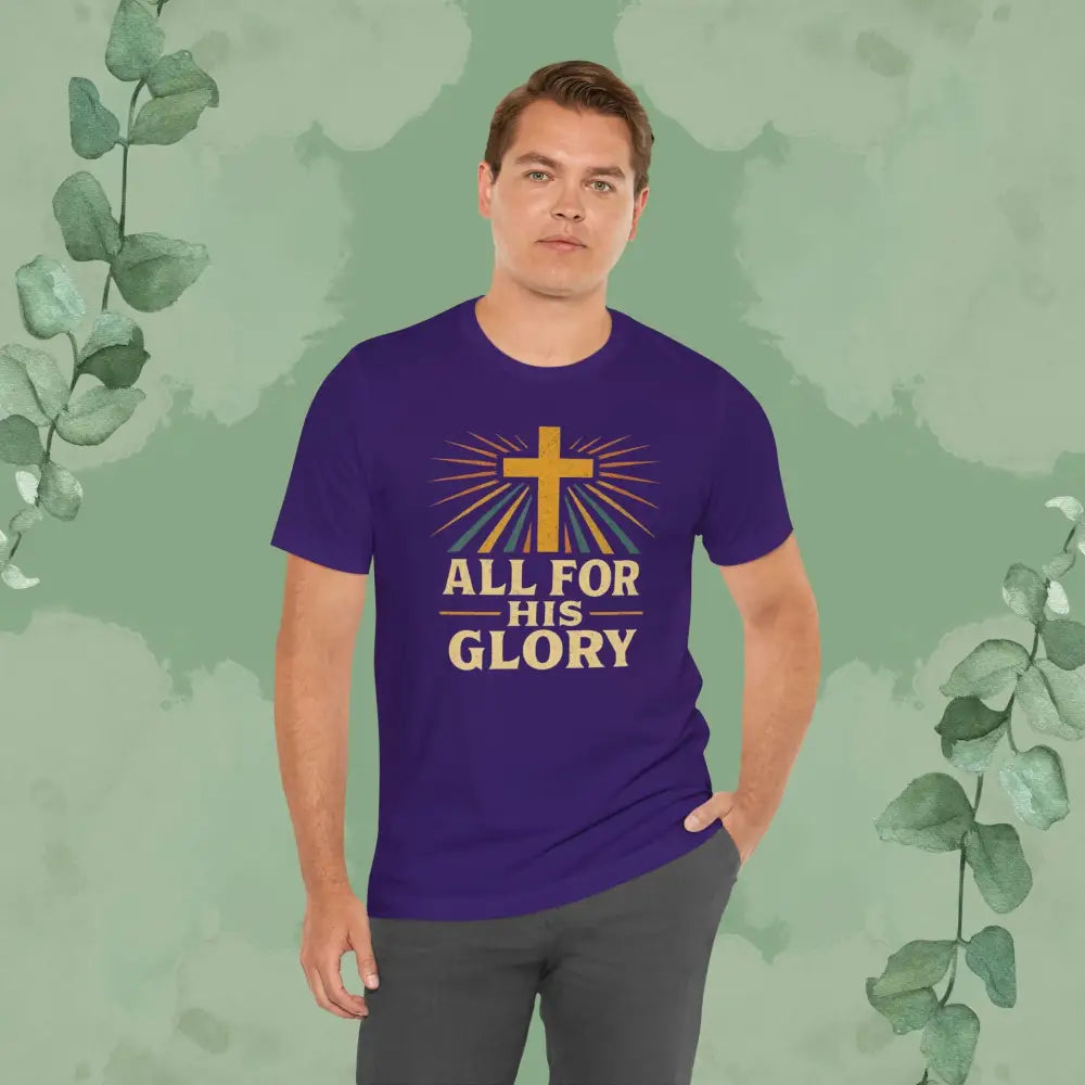 Man wearing a purple t-shirt with a cross and text on a green leafy background