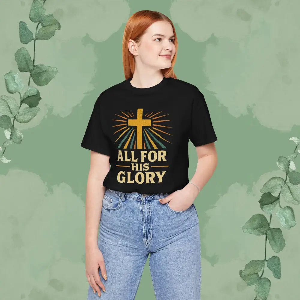 Person wearing a black t-shirt with a cross and text design on a green background