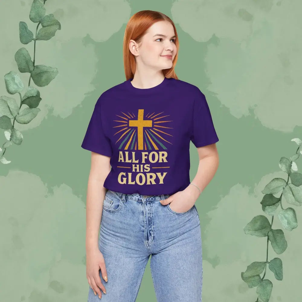 Person wearing a purple t-shirt with a cross and text design on a green background