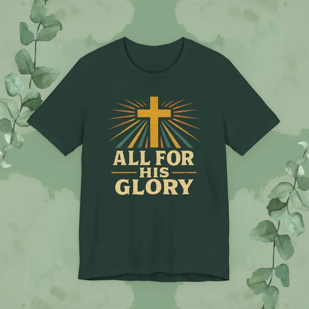 Dark green t-shirt with a cross and 'All for His Glory' text on a green background with eucalyptus leaves.