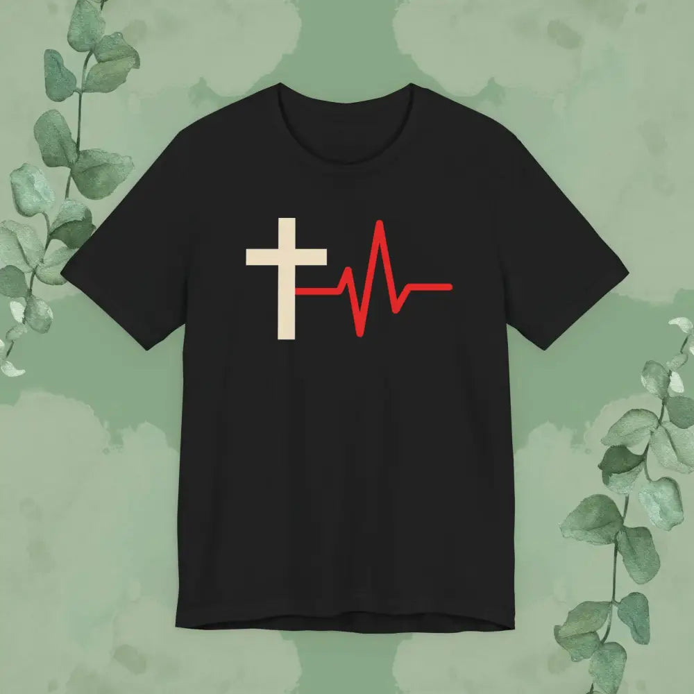 Black t-shirt with a white cross and red heartbeat line design on a green leafy background