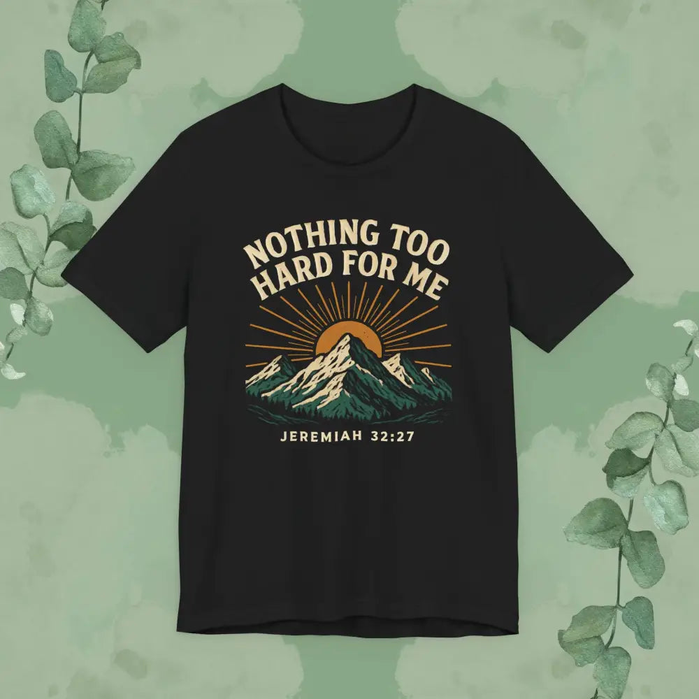 Black t-shirt with mountain design and text on a green background