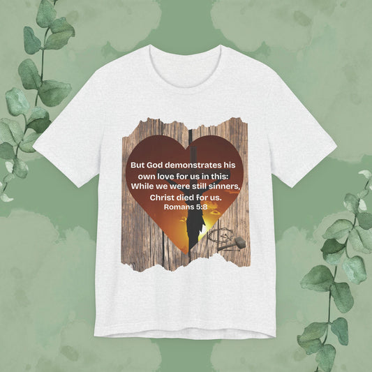 Ash Christian T-shirt with “Christ Died for Us” Romans 5:8 scripture heart design