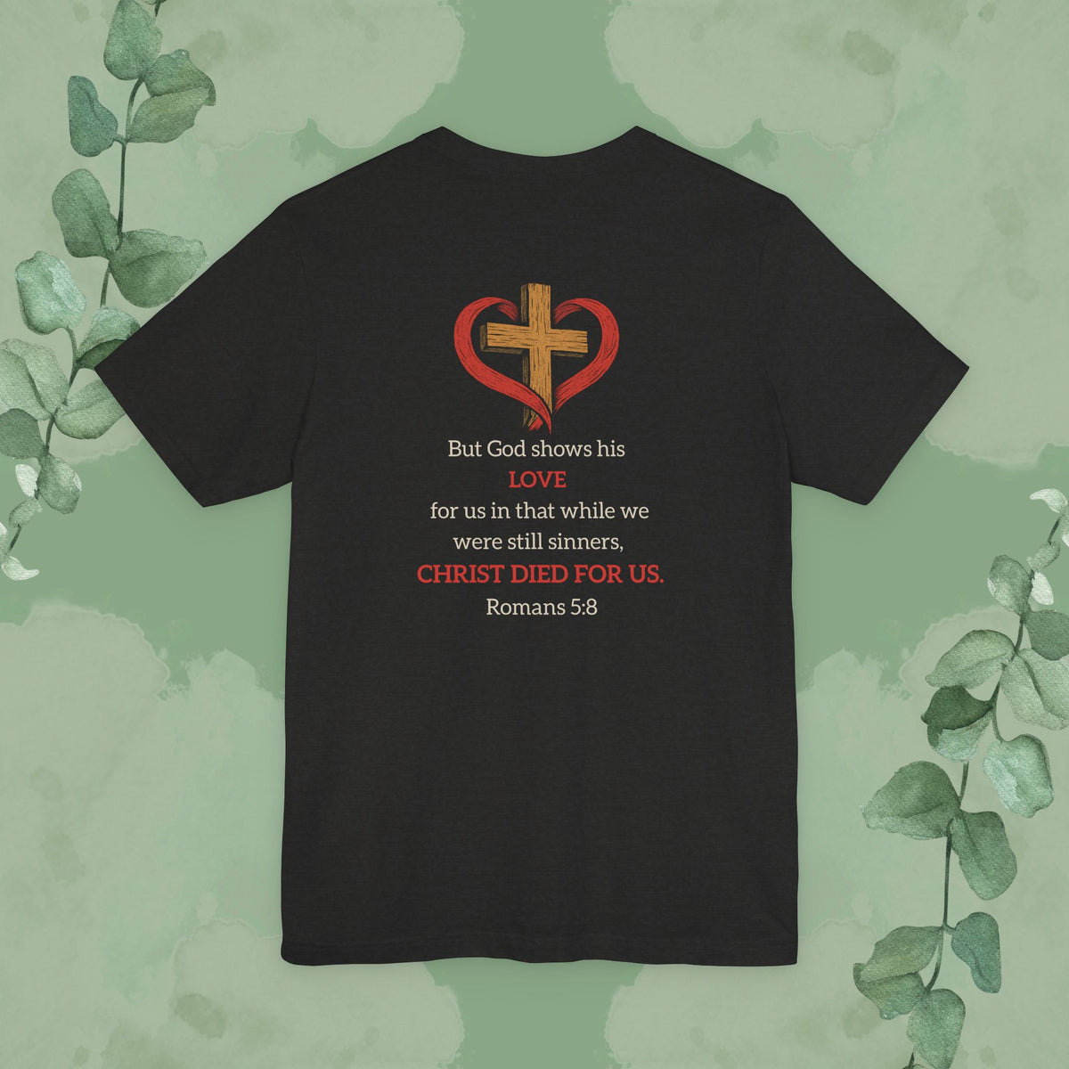 Black Heather Back Christian T-shirt with “While We Were Still Sinners” Romans 5:8 design