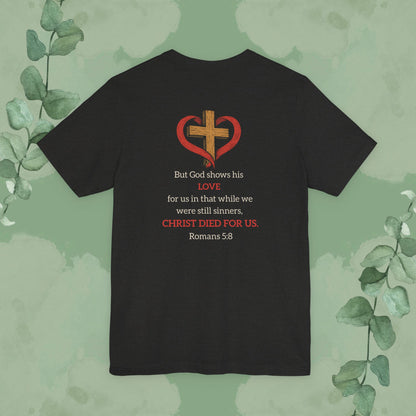 Black Heather Back Christian T-shirt with “While We Were Still Sinners” Romans 5:8 design