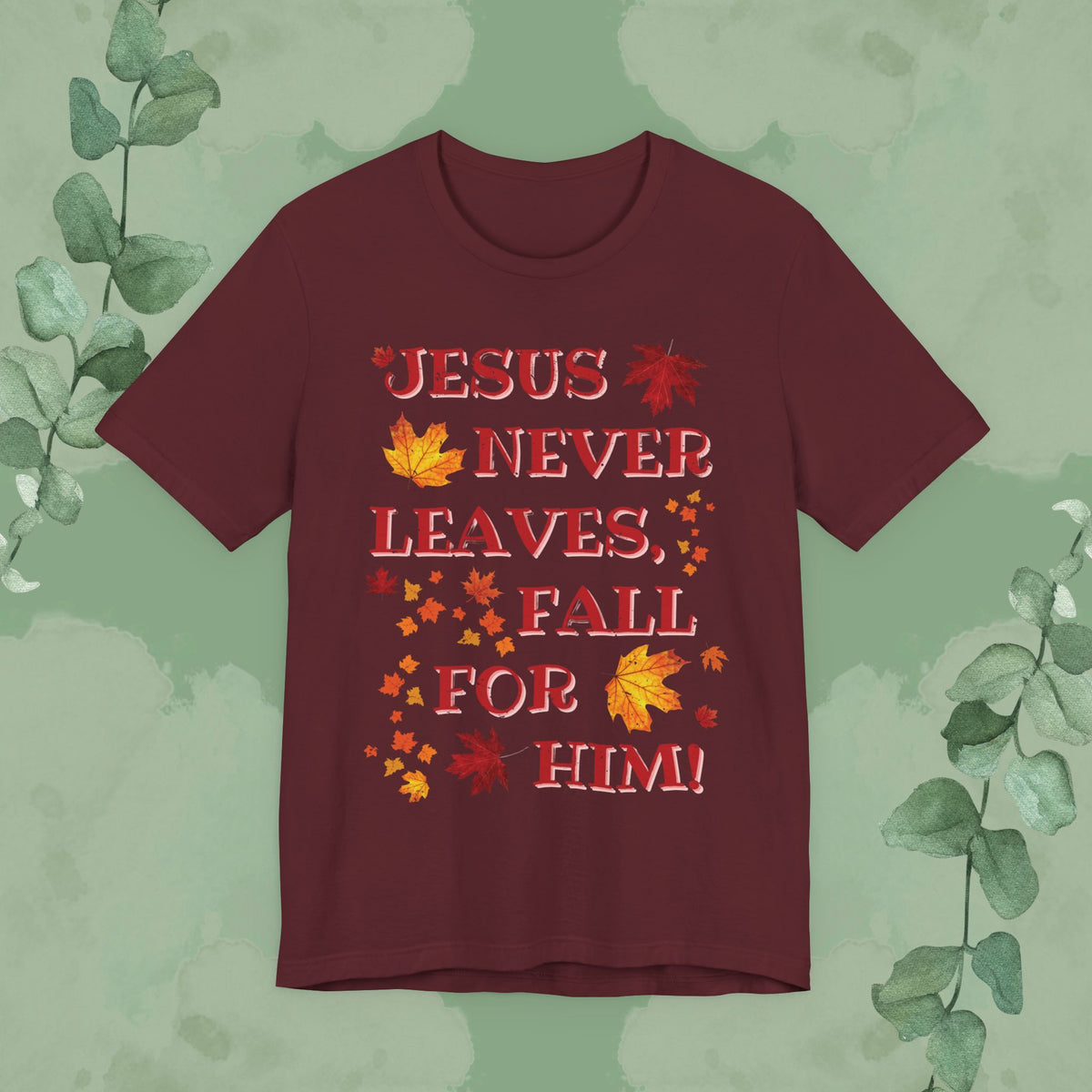 Maroon Christian T-shirt with “Jesus Never Leaves – Fall for Him!” autumn faith design