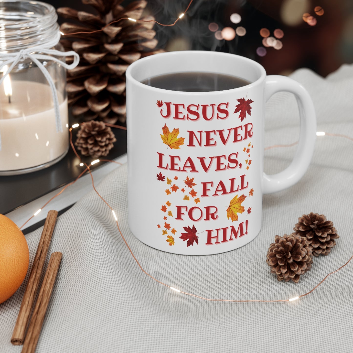 White Christian mug with “Jesus Never Leaves, Fall for Him” autumn faith design