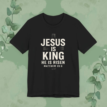 Black Christian T-shirt with “Jesus Is King – He Is Risen” and Matthew 28:6 design