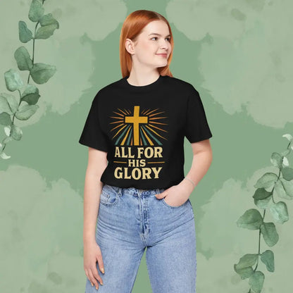 Person wearing a black t-shirt with a cross and text design on a green background