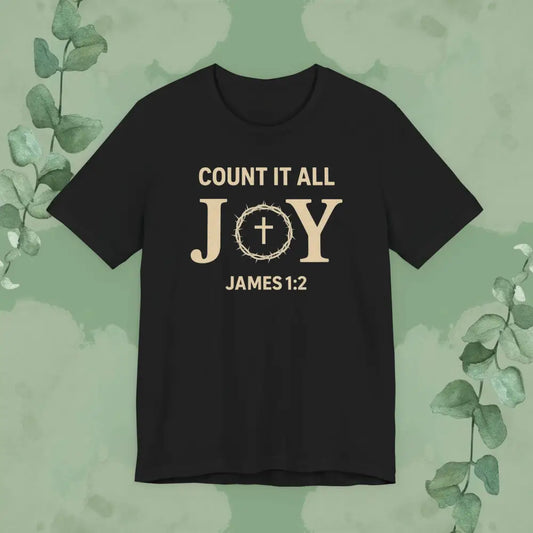 Black t-shirt with 'Count it all JOY James 1:2' text on a green background with eucalyptus leaves.