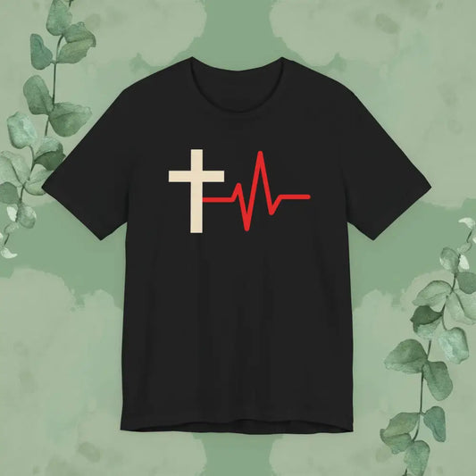 Black t-shirt with a white cross and red heartbeat line design on a green leafy background