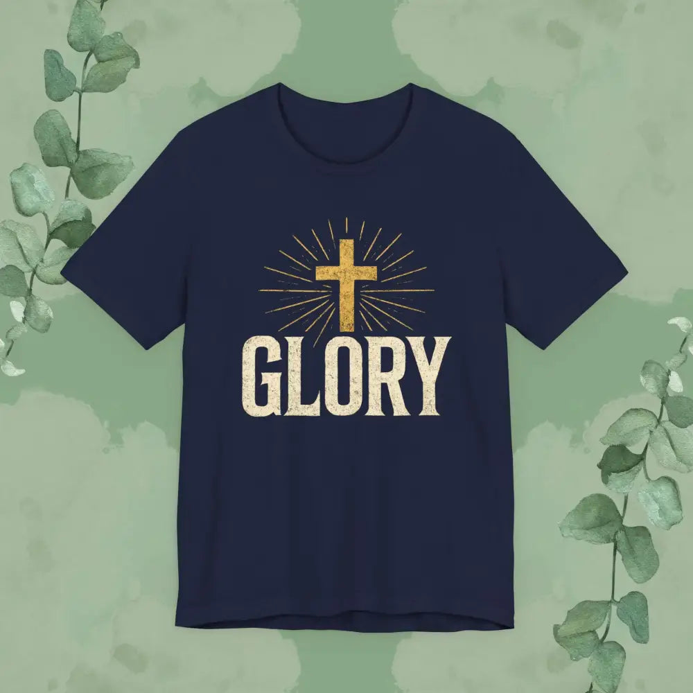 Navy blue t-shirt with a gold cross and 'GLORY' text on a green leafy background