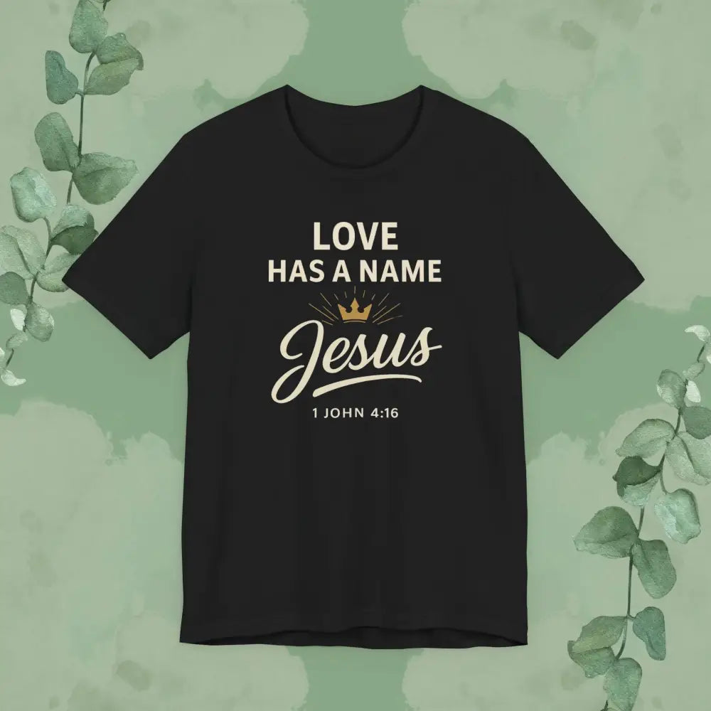 Black t-shirt with 'Love has a name Jesus' text on a green background