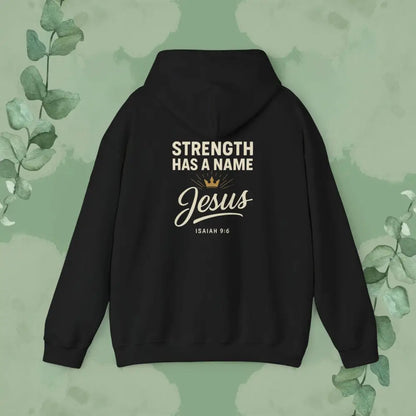 Black hoodie with 'Strength Has a Name Jesus' text on a green background