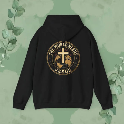 Black hoodie with 'The World Needs Jesus' design on a green background with leaves.